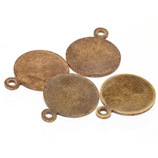 Oxidized brass round tabs with ring. Glue on to stones or cabochons.  8mm. diameter. Pkg 4. B9-2501