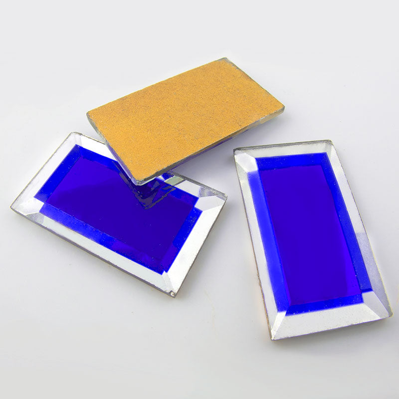 Vintage beveled silver foil cab with blue center. 28x15mm Sold individually.