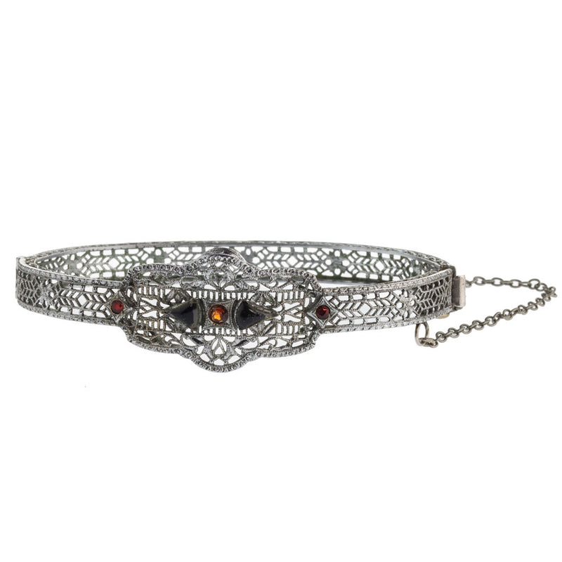 1930s Art Deco hinged rhodium filigree bangle bracelet with red and black glass stones.