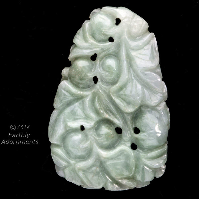 Vintage carved nephrite jade pendant depicting fruit tree and dog.