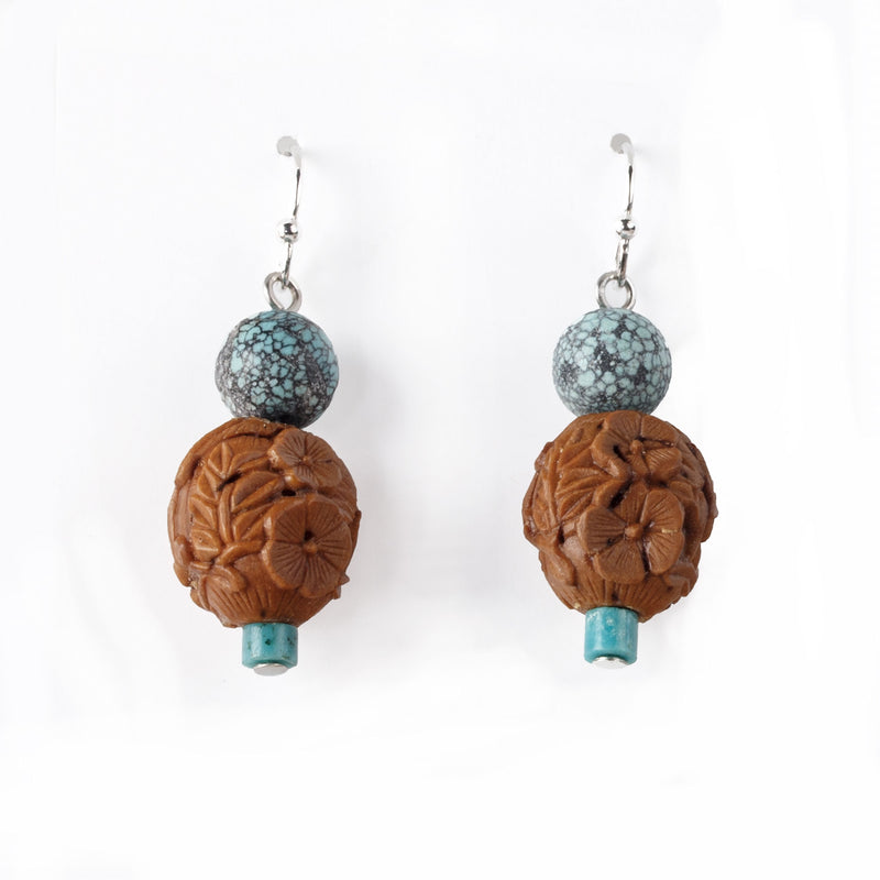 Earrings made of vintage Chinese carved fruit pit and spiderweb turquoise beads.