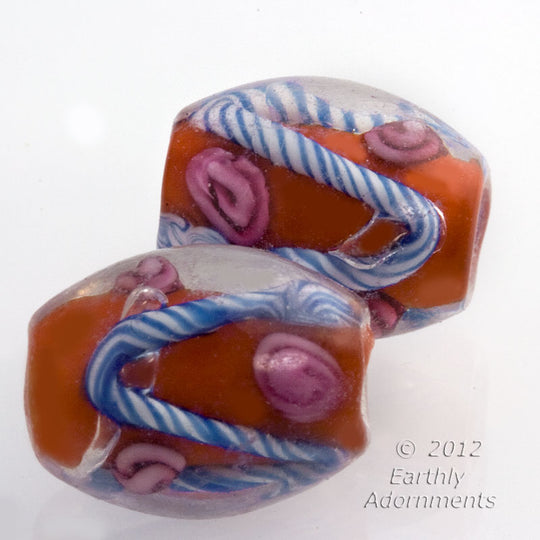 Contemporary red glass with pink rosettes and white and blue trailings, under clear glass dome, 10x12mm. Pkg. of 4. b11-rd-0853