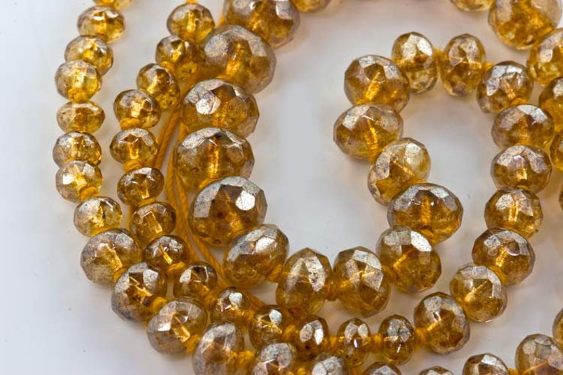Graduated knotted strand gemstone-cut citrine luster glass bead strand.16 in. strand. 
