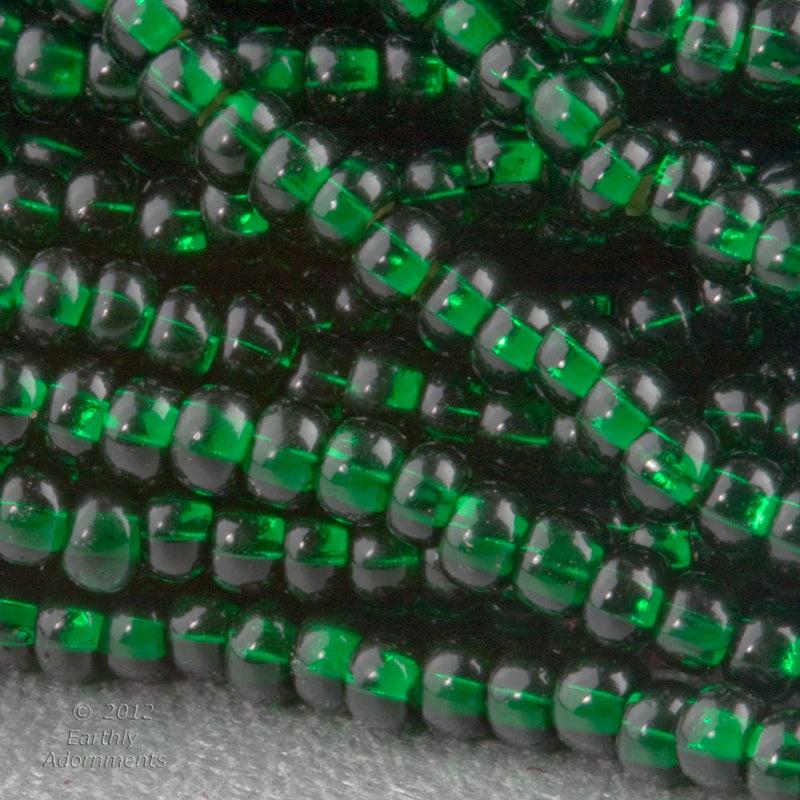 Vintage Italian two tone seed beads light lavender glass with emerald green foil core. 10 gram bag. 