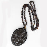 -Vintage carved openwork tortoise shell pendant on a tortoise shell link chain