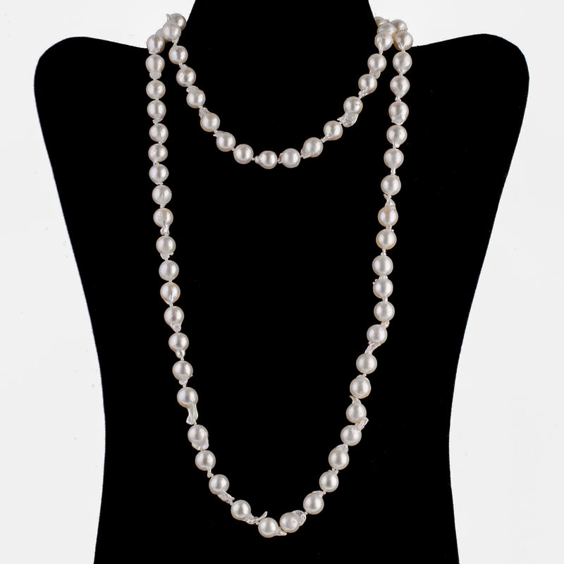 Necklace of vintage semi-baroque Japanese Akoya cultured 9mm pearls, 35 inches. 14k gold clasp. C. 1950s