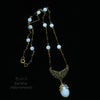 Edwardian style sautoir necklace of vintage opal glass and brass bar chain.