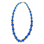 Vintage necklace of luminous blue translucent glass beads and brass filigree beads.  22 1/2 inches. 1920s-30s.  Czechoslovakia