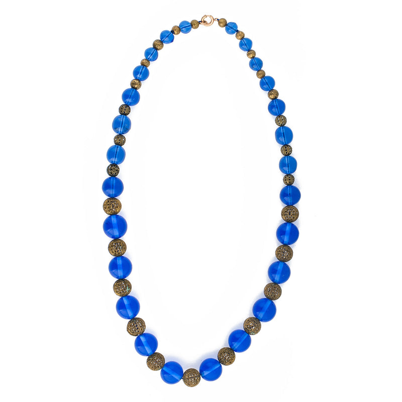 Vintage necklace of luminous blue translucent glass beads and brass filigree beads.  22 1/2 inches. 1920s-30s.  Czechoslovakia