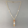 Necklace of vintage Bohemian clear and amber glass beads with flower tassel