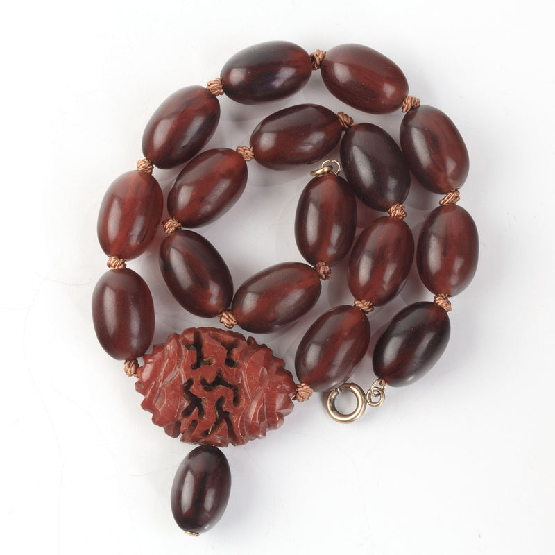 Vintage Bakelite Amber oval bead necklace with carved Bakelite focal bead