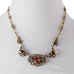 Early 20th c. necklace of layered brass and glass stones.