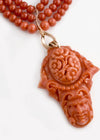 Rare Mediterranean salmon coral carving with an oval opal cabochon on the reverse, 14k rose gold metal work and a triple strand of coral beads