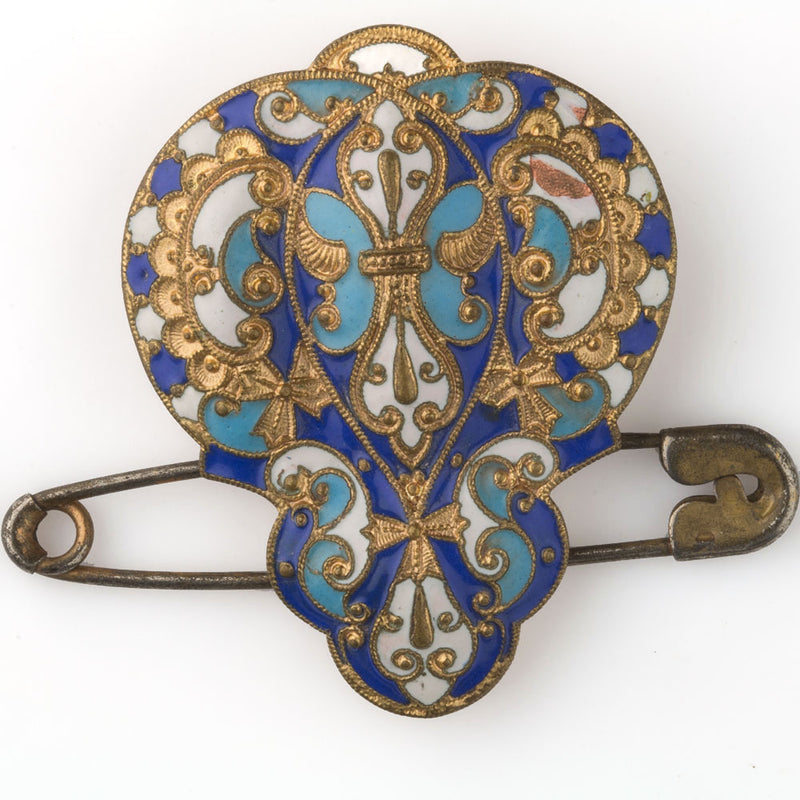 Antique enamel dress clip with attached safety pin.
