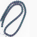 Contemporary Czech emerald and violet glass 6mm rounds, strand of 75.