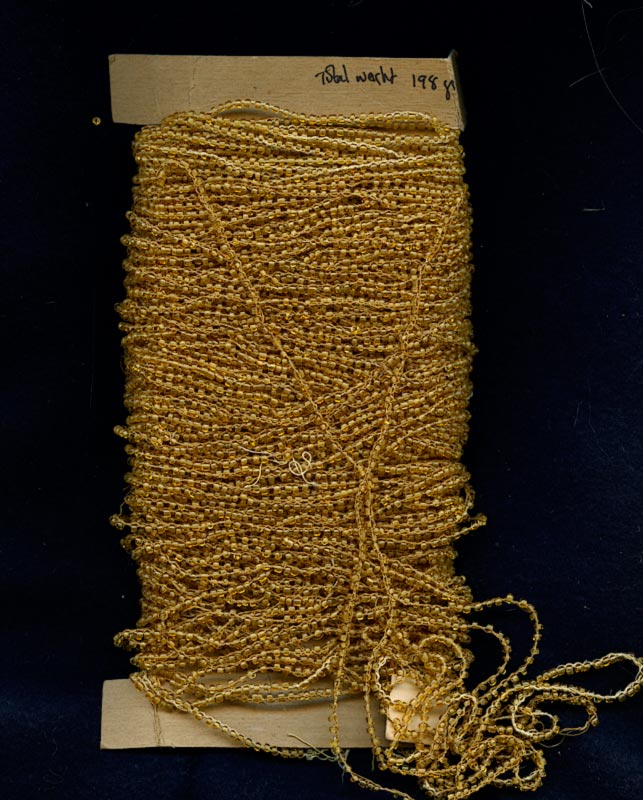 Vintage honey opalescent rocailles, size 9 on braided string per foot. 